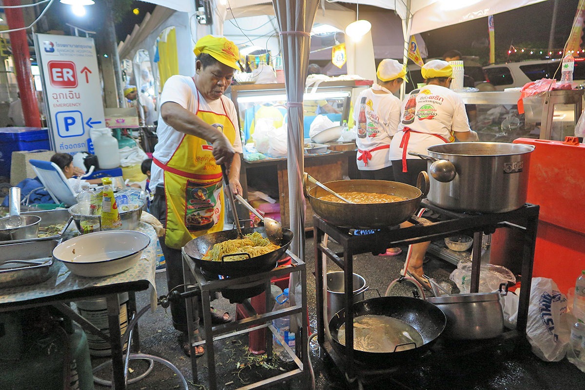 You need to be dedicated to cook on the streets - this guy on Yaowarat Road definitely is! - street food in Bangkok