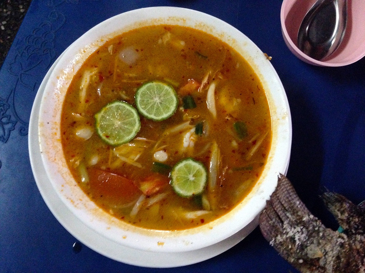 Part of our big first dinner for a few bucks - delicious soups, whole fish and veggies! - street food in Bangkok