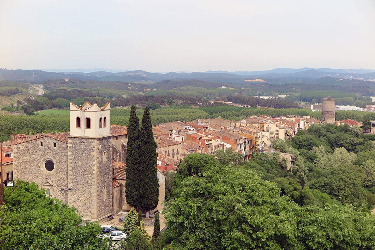 Hostalric town, with the church in the foreground and Frares tower in the background