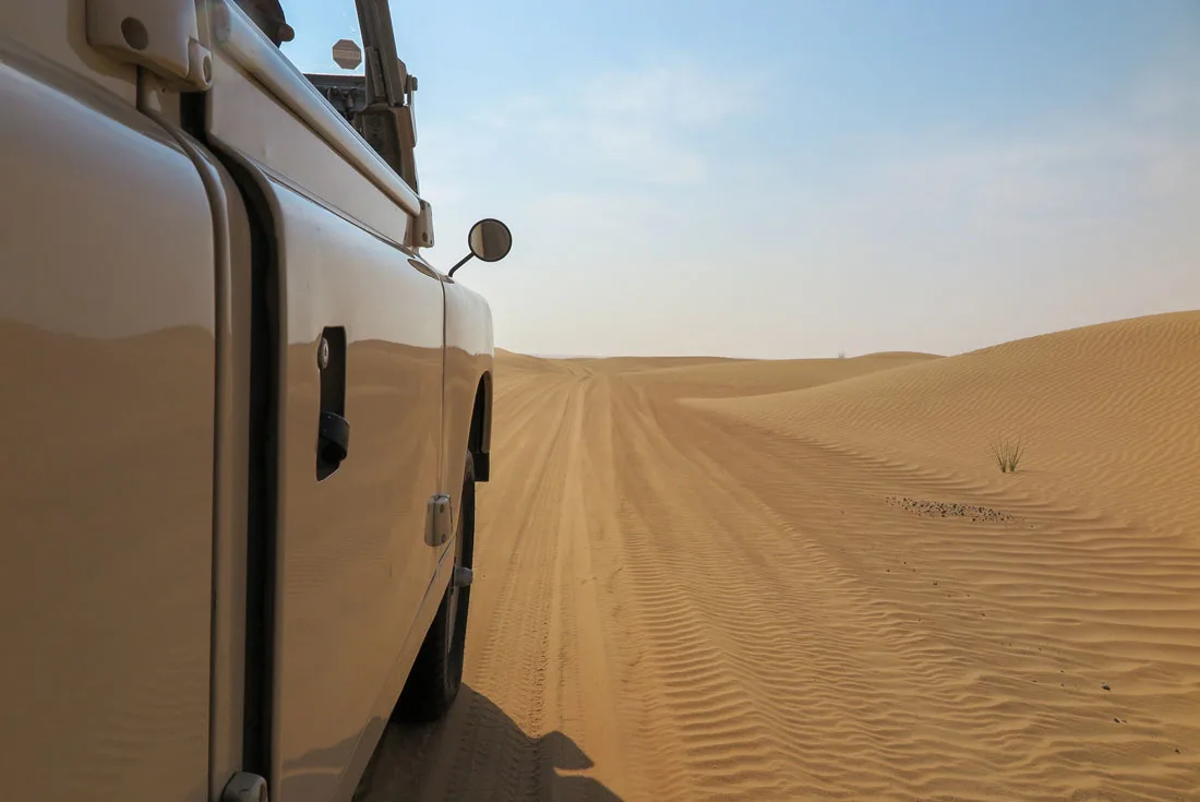 Riding a Land Rover in the desert of Dubai.