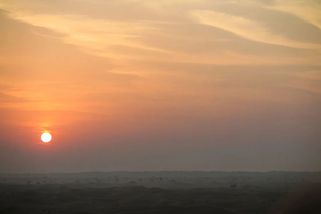 Sun rising above Dubai desert