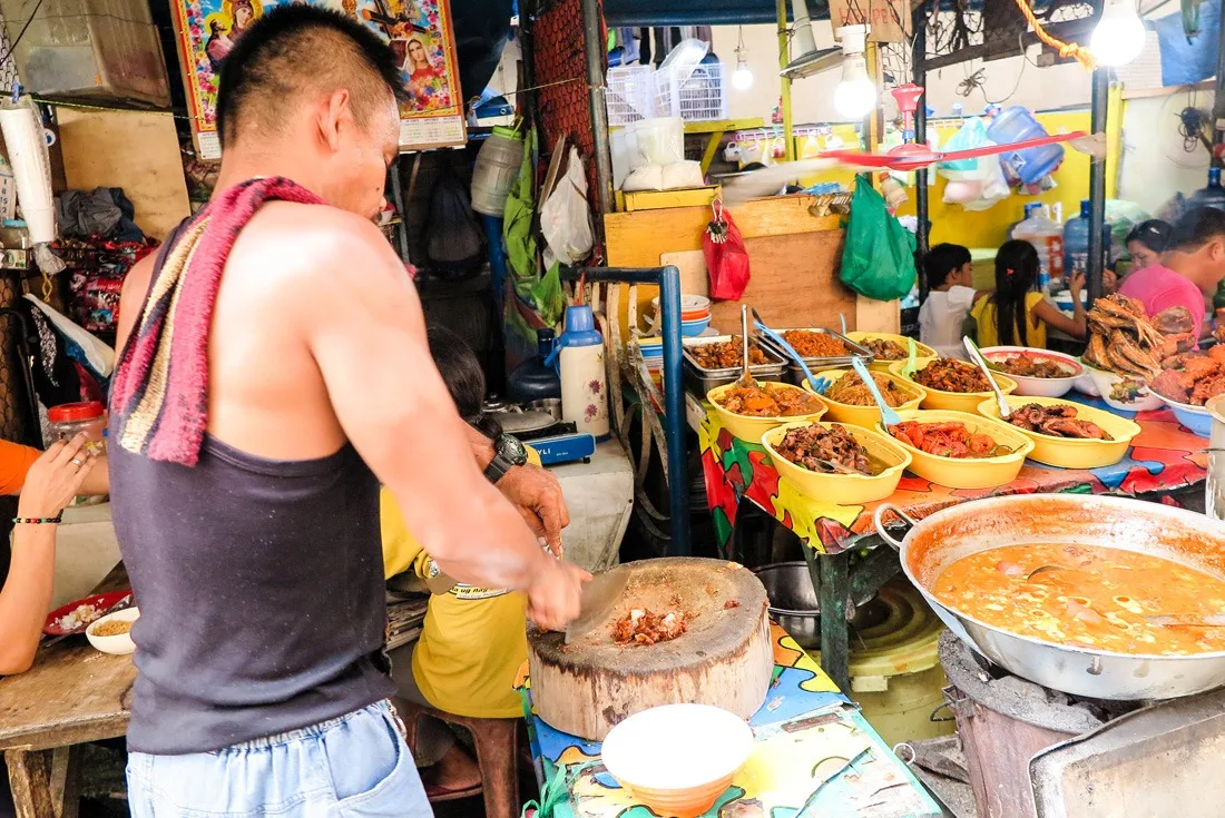 Cutting fried por intestines into chunks. Cebu, Philippines. www.travelgeekery.com 