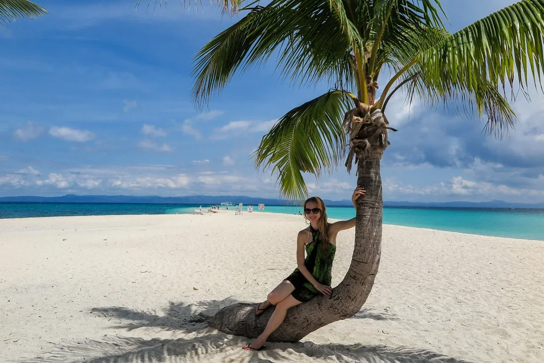 Resting in the shade of a coconut palm tree.. Kalanggaman, Philippines