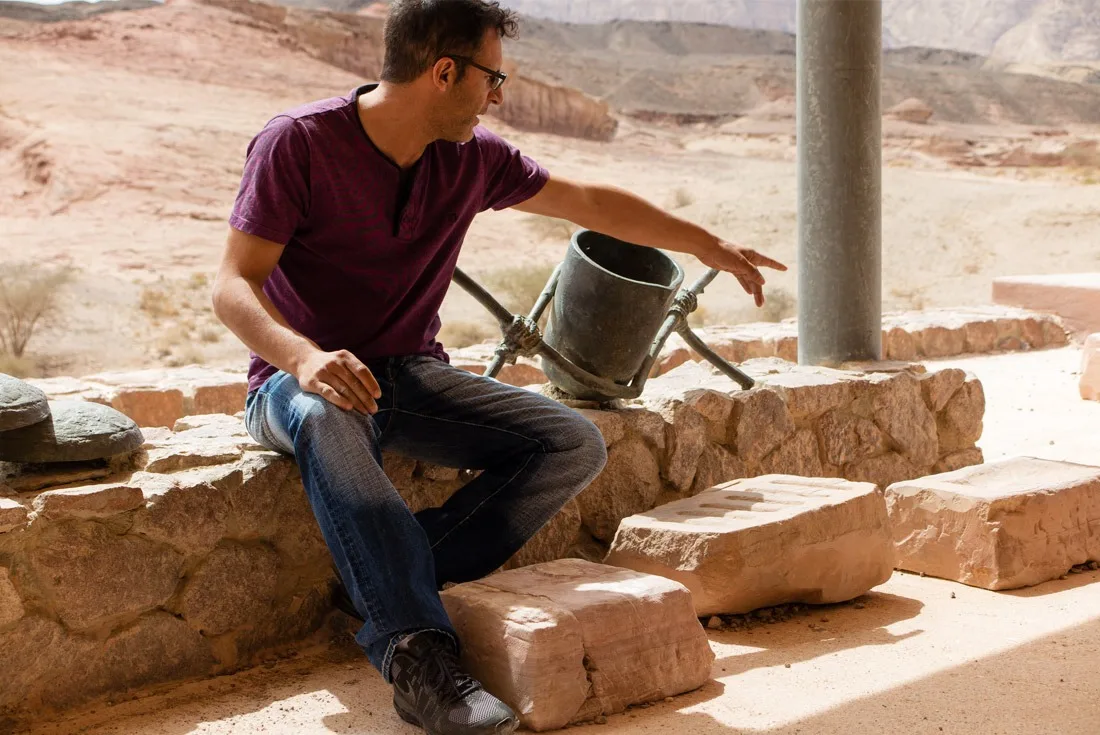 A guide in Timna National Park explaining the copper smelting process