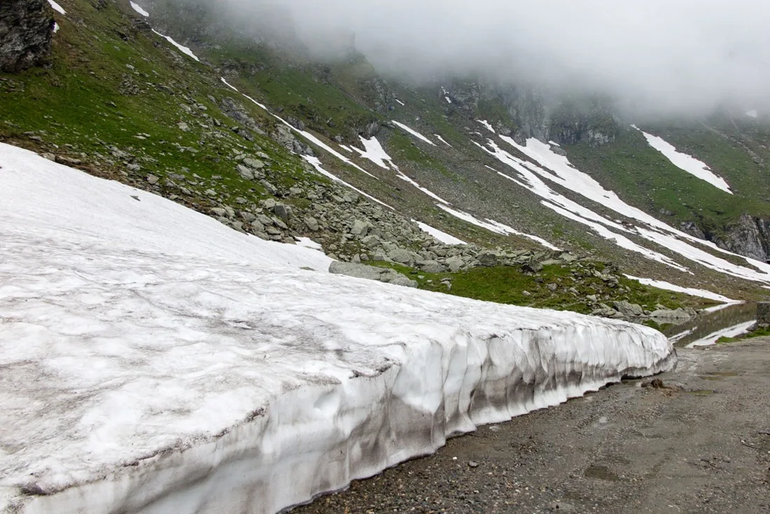 A layer of snow by the road on top of Transfagarasan.