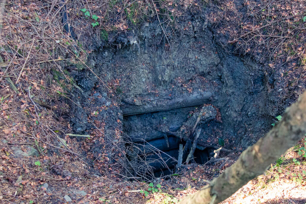 Hand dug hole for crude oil extraction near city Gorlice
