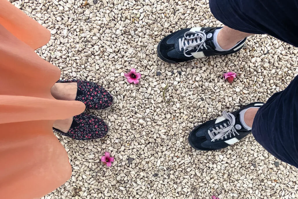 Close up of 2 pairs of feet in shoes