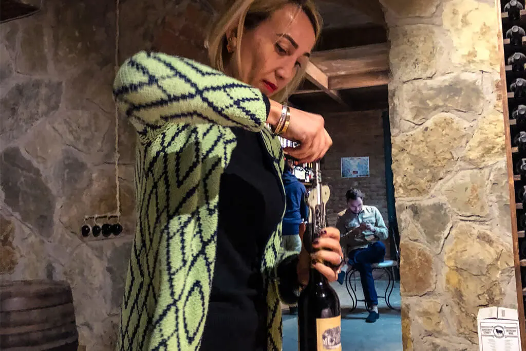 Opening a bottle of wine at Royal Wine bar in Tbilisi Georgia