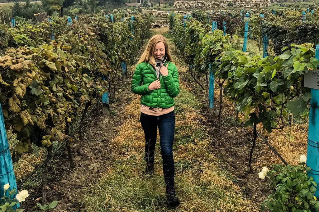 Veronika of TravelGeekery strolling the vineyards of Shumi Winery