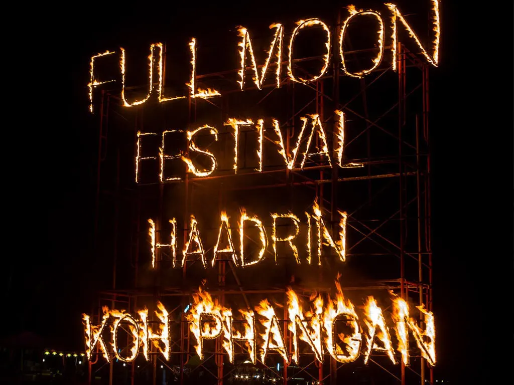 Sign made out of fire spelling "Full Moon Festival Haad Rin Koh Phangan"