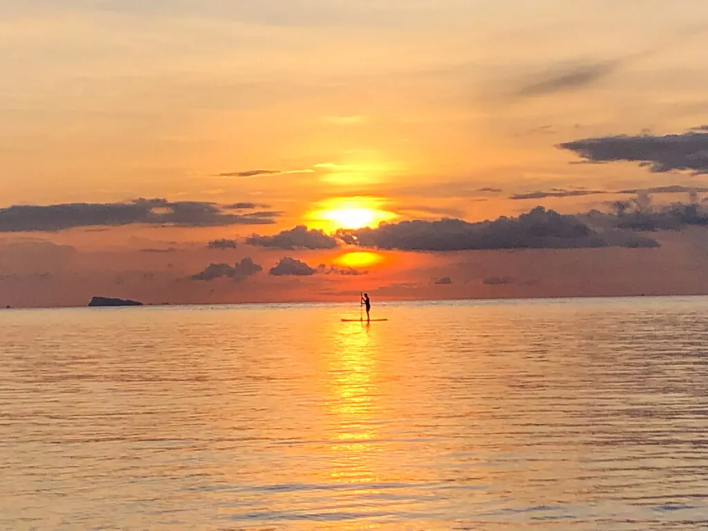 Stand up paddleboard upon sunset