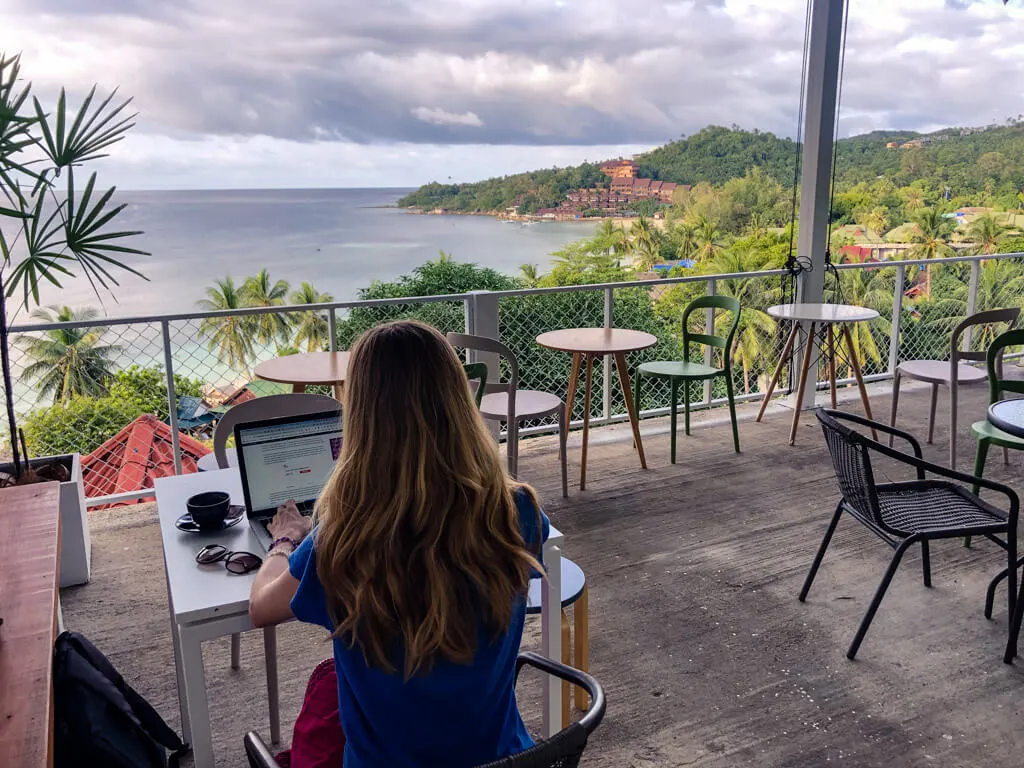 Working at a laptop with a view of the ocean