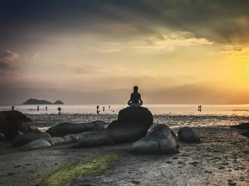 A man meditating on a rock