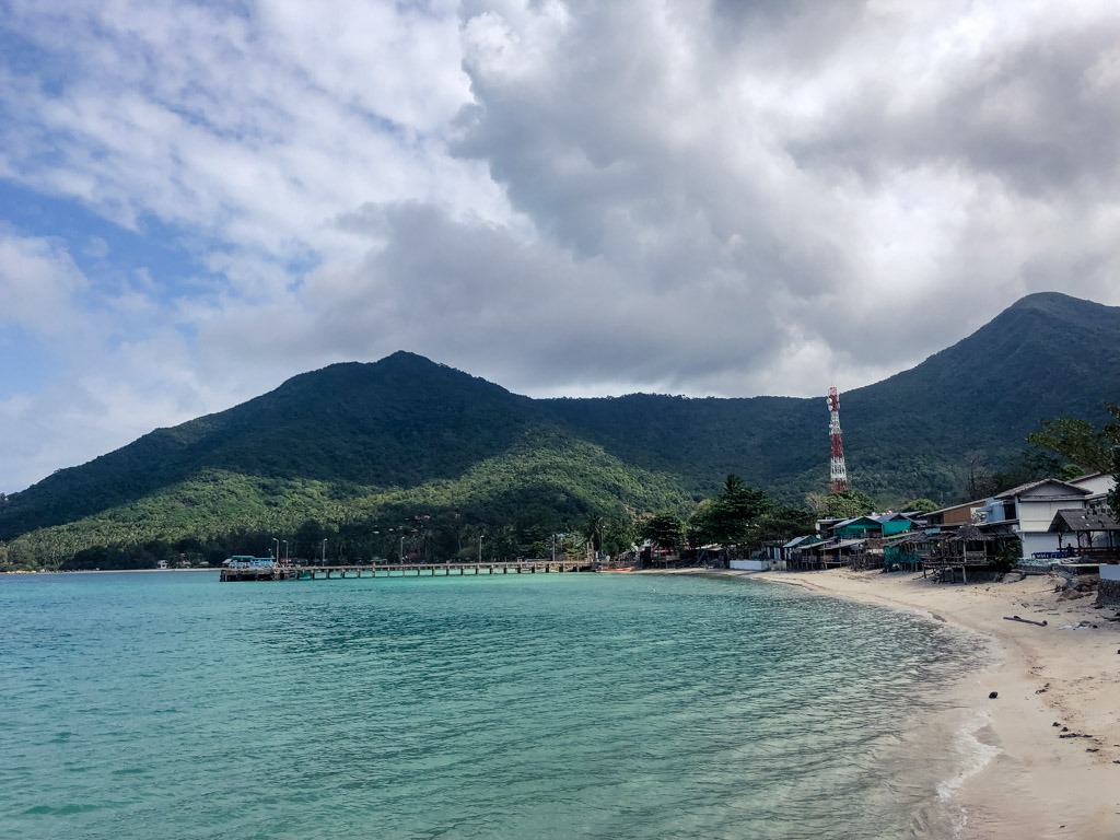 Bay of Chaloklum Koh Phangan with a mountain backdrop and a cloudy sky