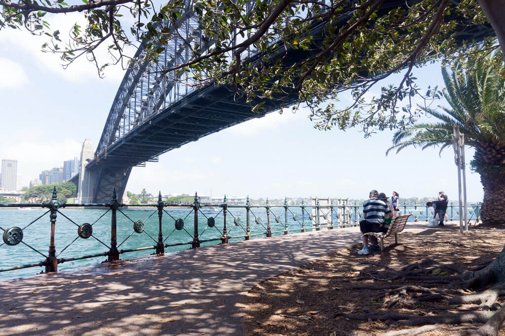 A seaside path under Sydney's Harbour Bridge