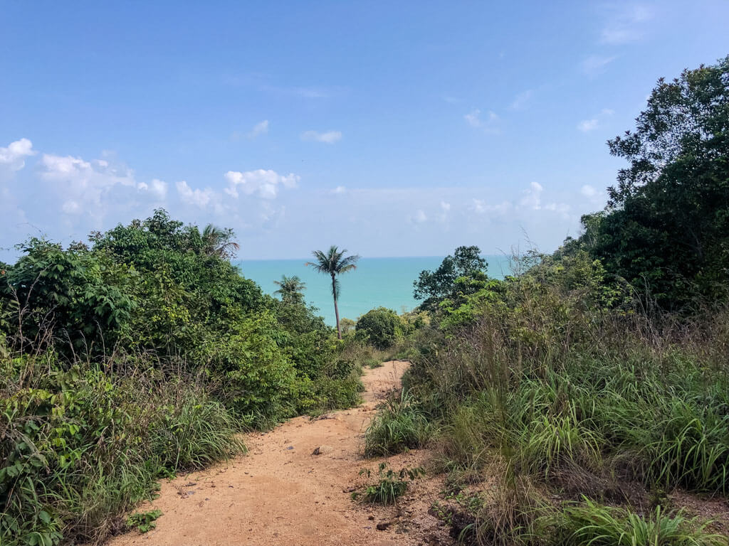 A dirt path with the sea in the distance, Koh Phangan