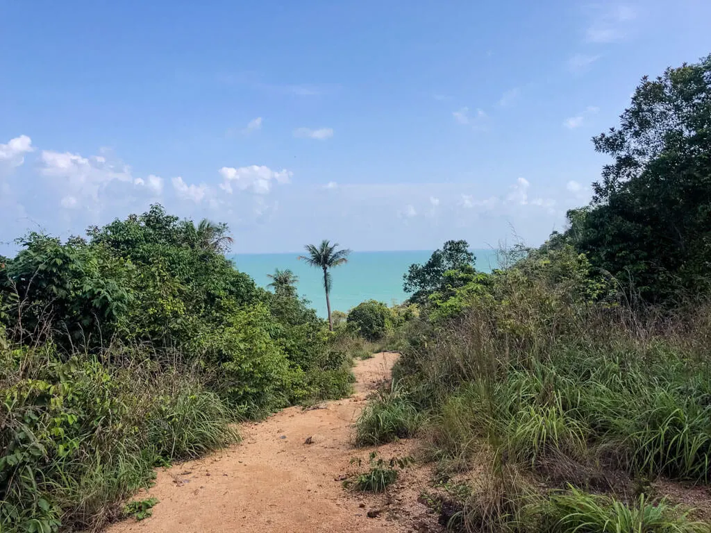 A dirt path with the sea in the distance, Koh Phangan