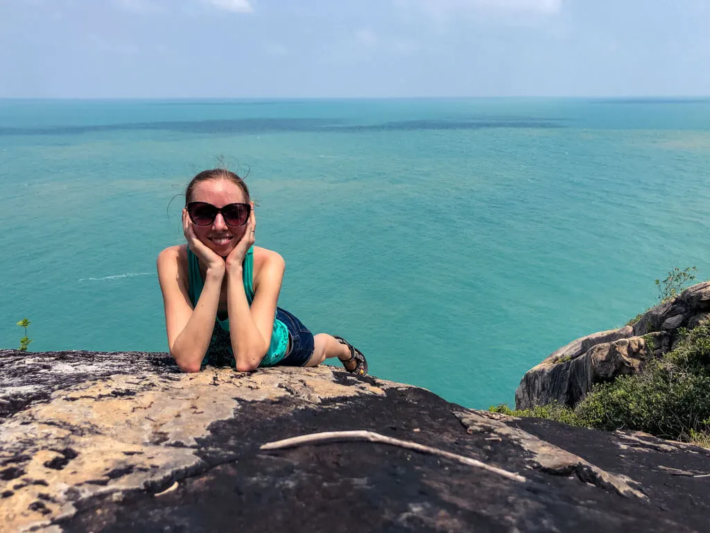 Posing on a large boulder above the sea