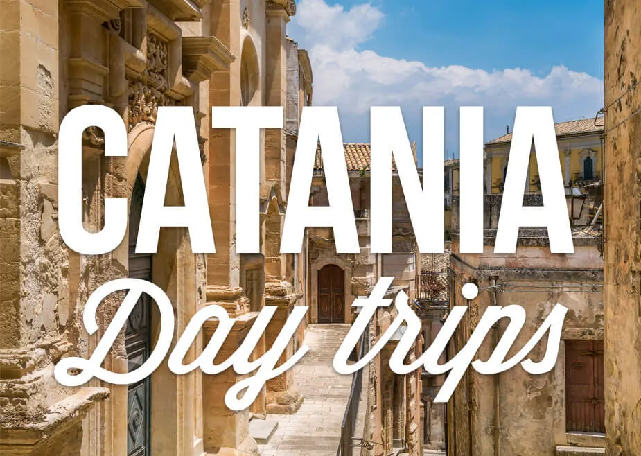 A Sicilian town with text overlay "Catania Day Trips"