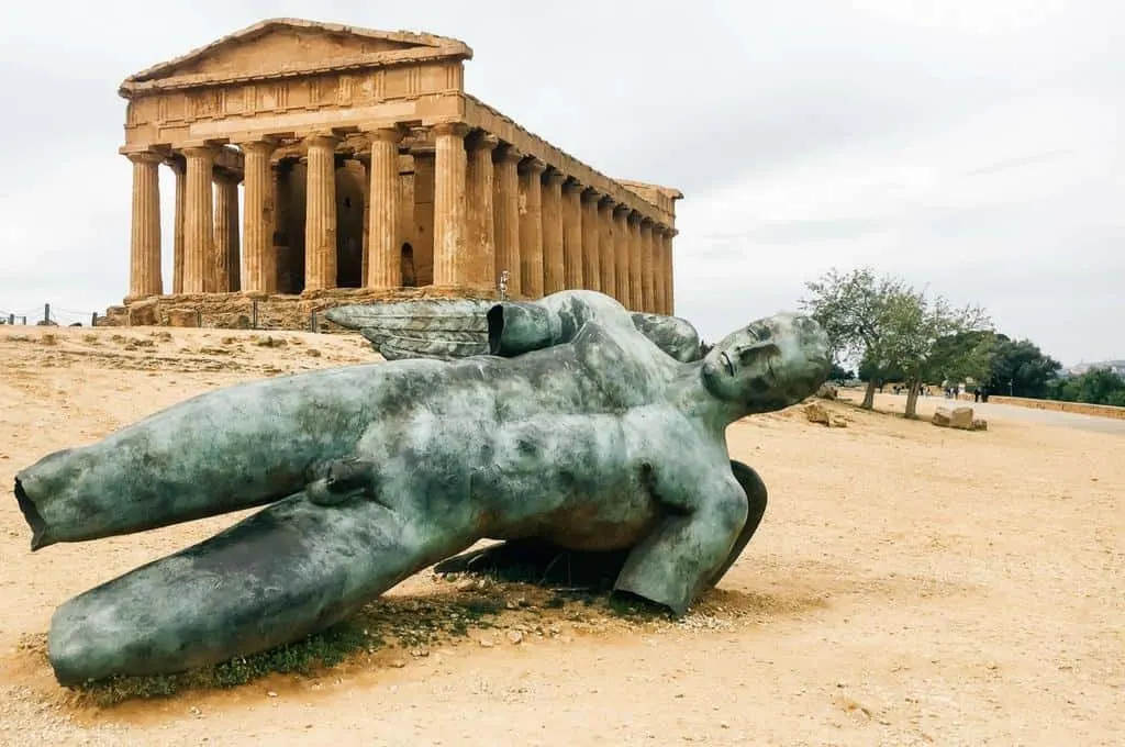 Valley of the Temples in Agrigento with a statue lying in front