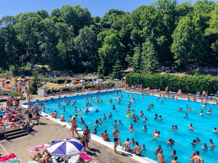 View of a busy outdoor swimming pool in Prague