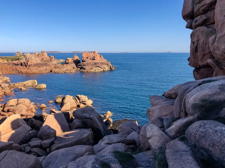 A cove framed with rocks on the Cote de Granit Rose in Brittany