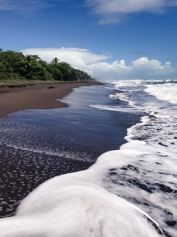 tropical beach with black volcanic sand