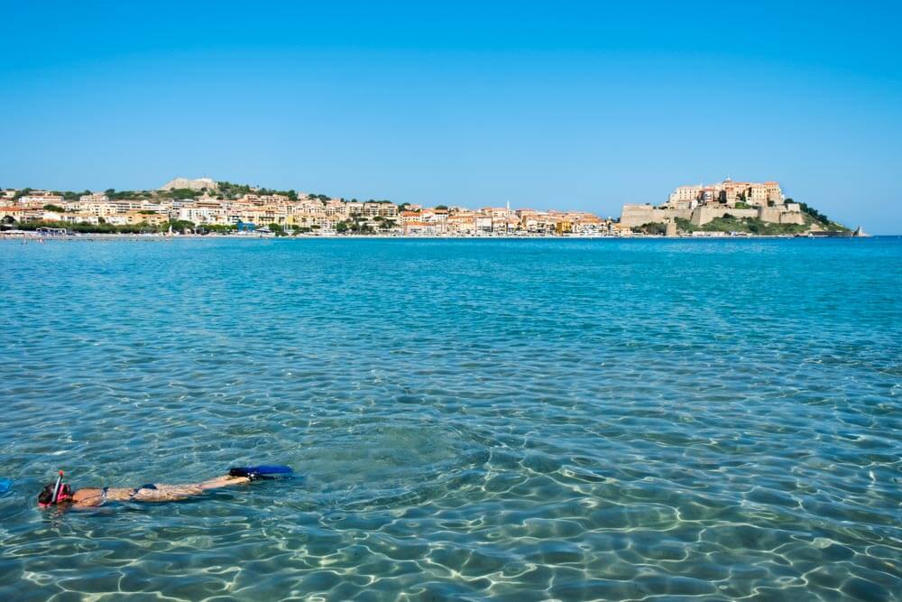 A woman snorkeling on Calvi Beach in Corsica