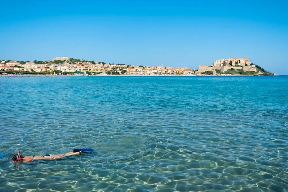 A woman snorkeling on Calvi Beach in Corsica