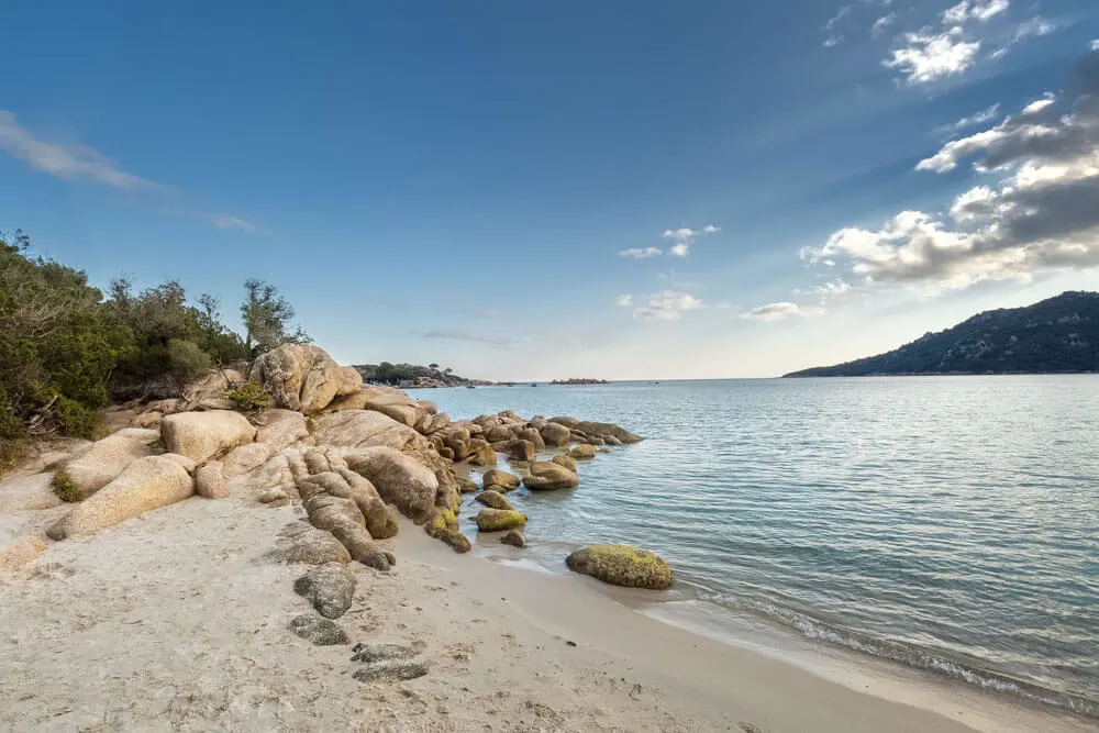 White sand beach with boulders in Corsica France