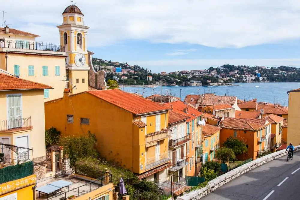 View of colorful houses and a church tower in Villefranche sur Mer, France