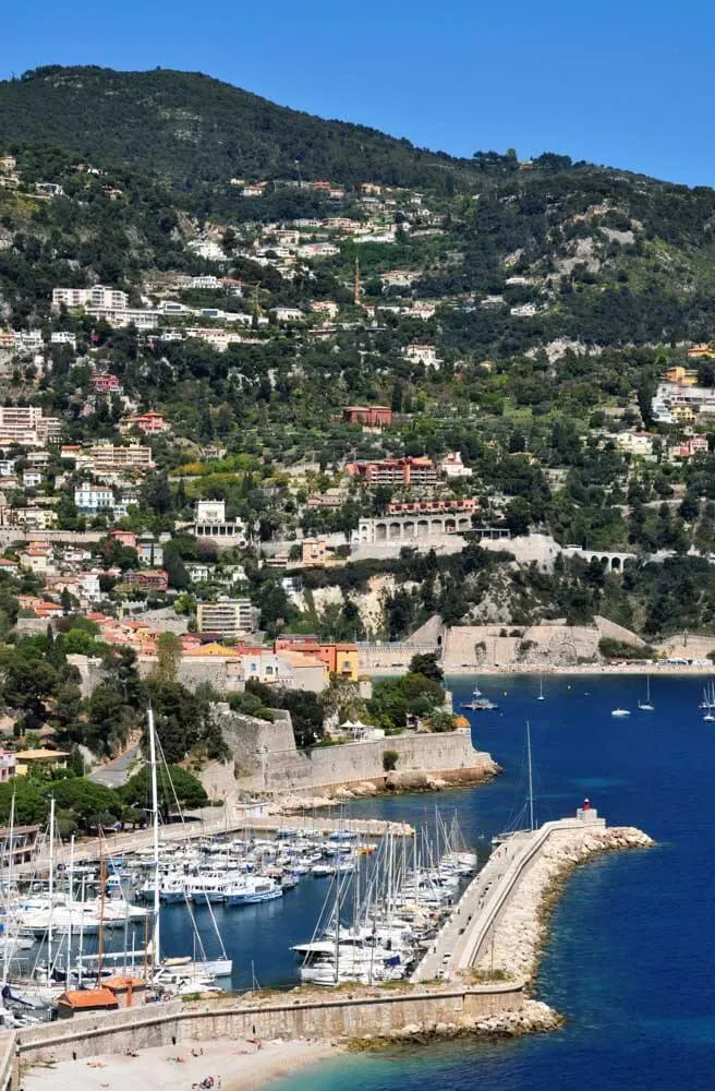 View of a long pier and a small lighthouse at the Port of Villefranche near Nice, France