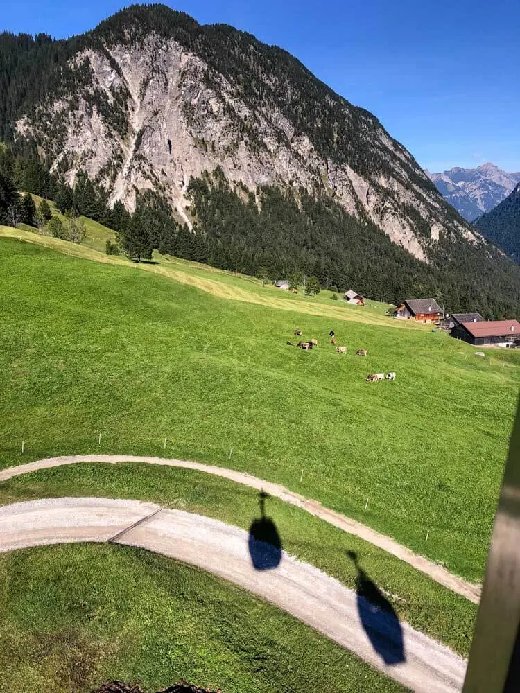 Shadow of a cable car rising to the mountains