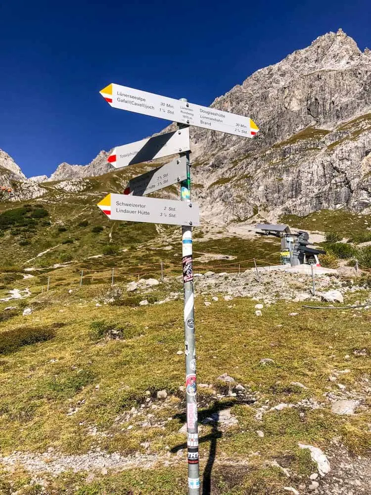 A signpost with hiking trail marks in Vorarlberg Austria