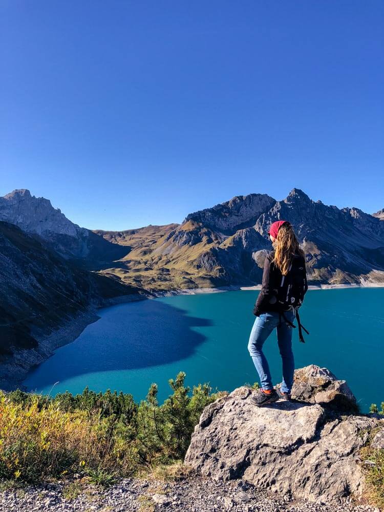 Veronika from TravelGeekery watching the turquoise lake Lünersee