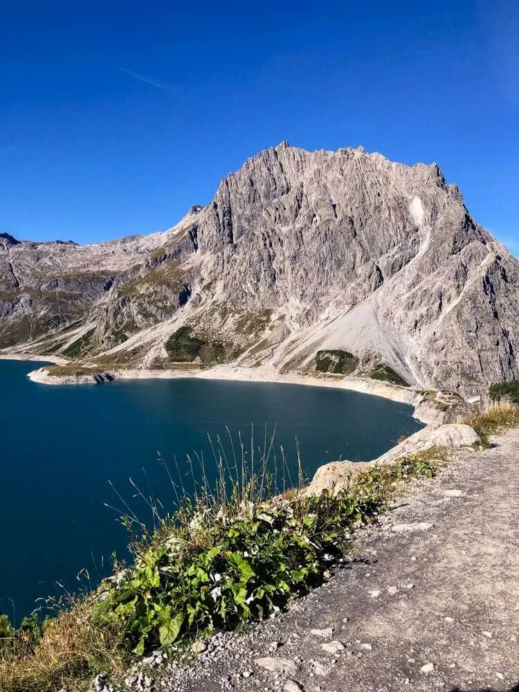 Dramatic mountain peaks lining lake Lünersee