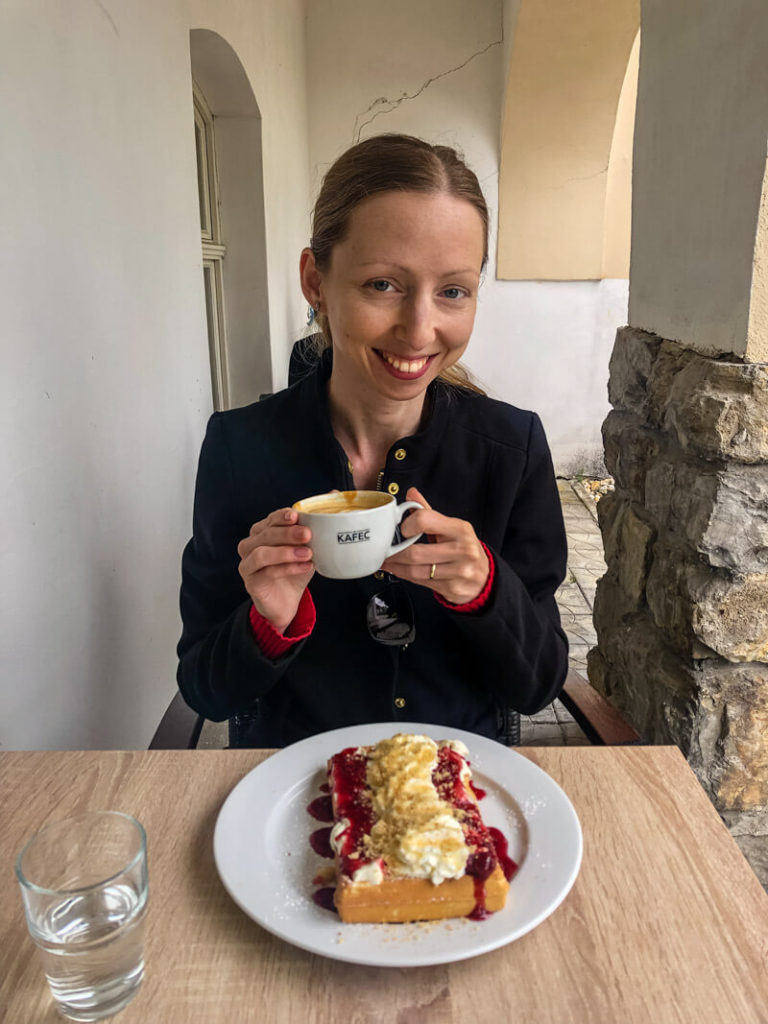 Veronika enjoying a waffle in a café