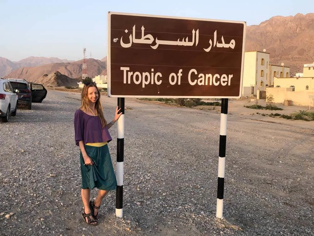 Veronika posing with a sign of Tropic of Cancer in Oman