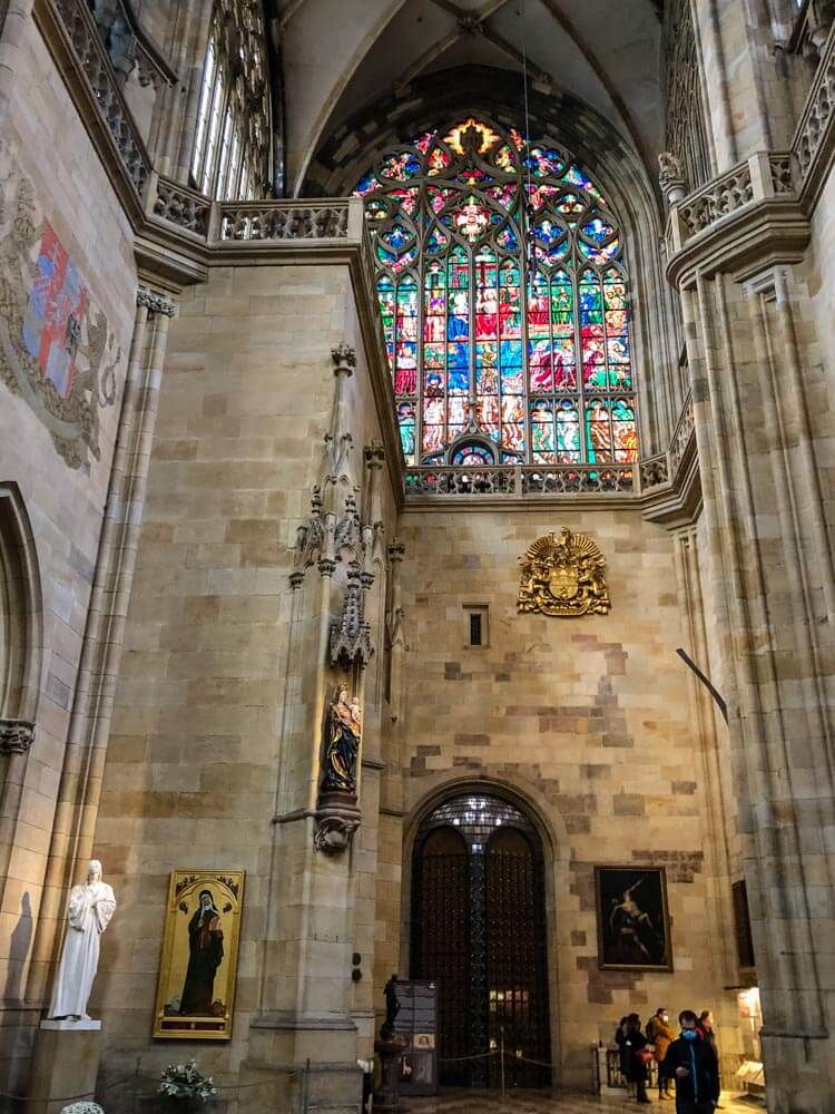 Gothic features and stained glass windows inside Saint Vitus Cathedral Prague