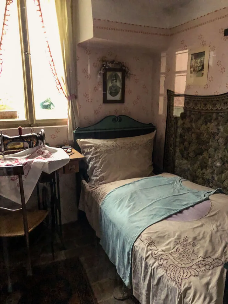 View of a bed and a desk inside a house on the Golden Lane Prague Castle