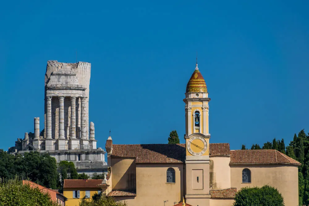 A roman ruin and a church in a French village of La Turbie