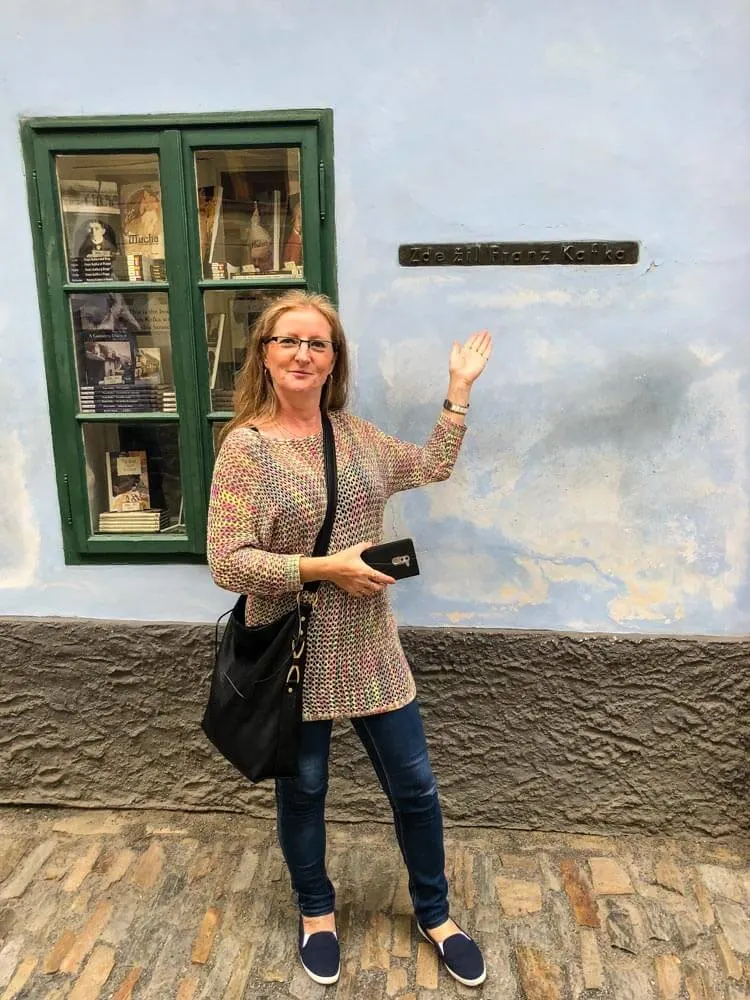 Veronika's mother pointing to a house in the Golden Lane, Prague Castle