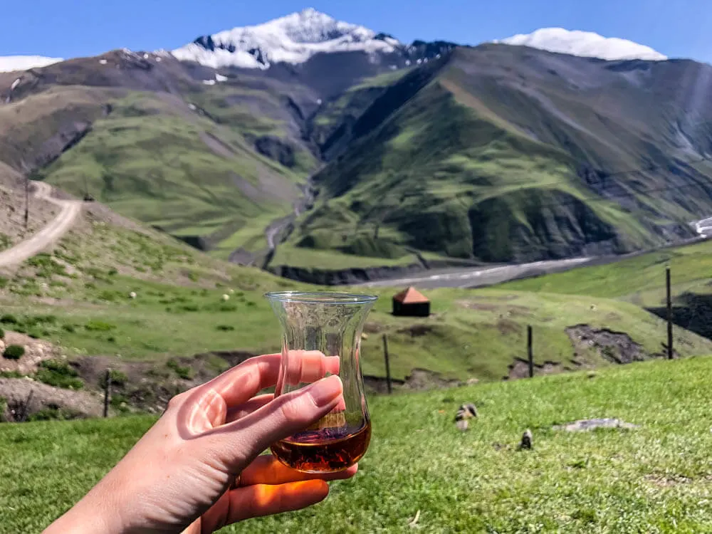 Drinking tea with the view of snowy mountain peaks