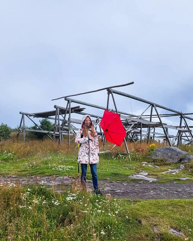 Veronika in a travel raincoat posing in rain in Norway