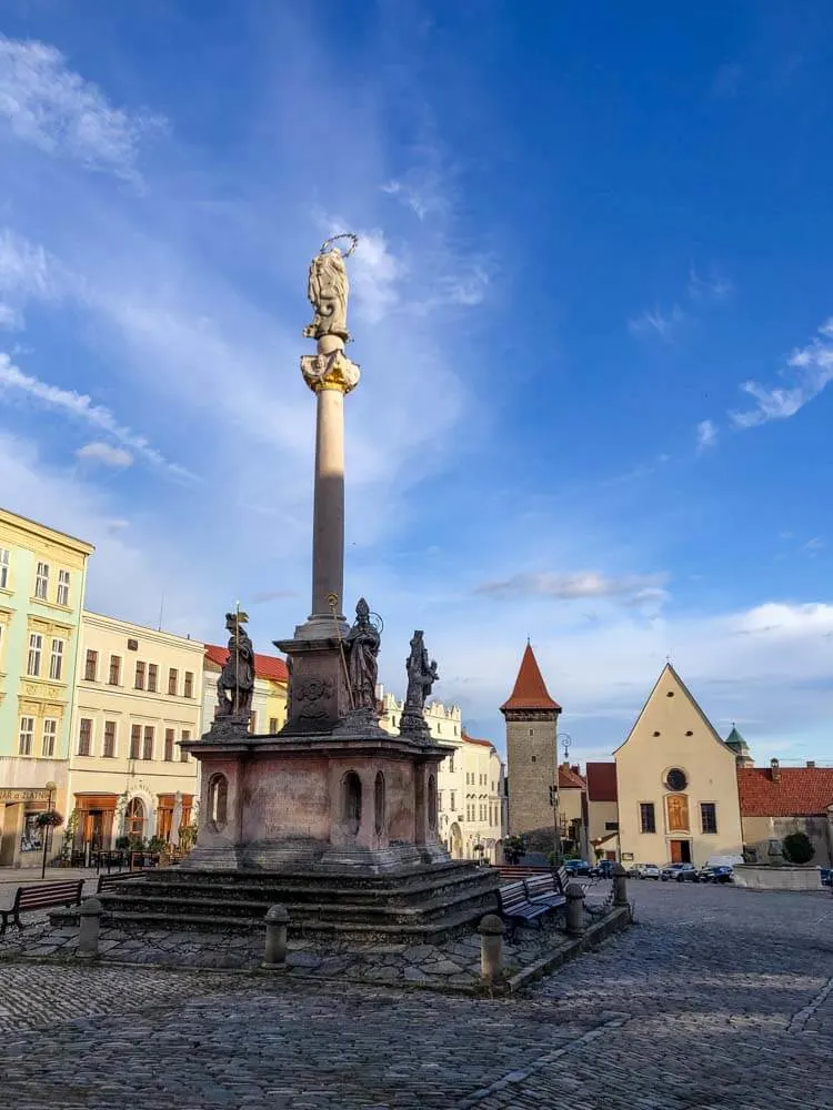 Znojmo's Masaryk Square with a plague column and Wolf's Tower in the background.