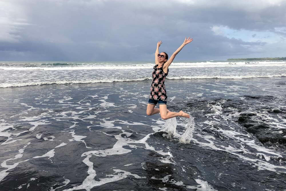 Veronika jumping on a beach in Costa Rica