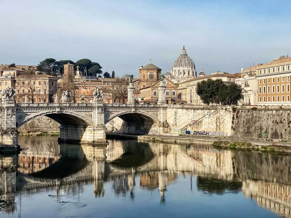 View of a bridge in Rome with St. Peter's Basilica in the background