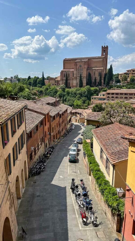 View of Siena's Basilica San Domenico and a street leading towards it