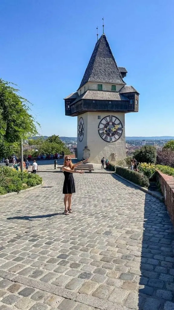 Veronika posing in front of Graz' famous clock tower called Uhrturm