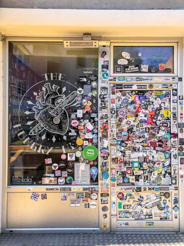 A closed street food bistro in Graz with a door covered in stickers